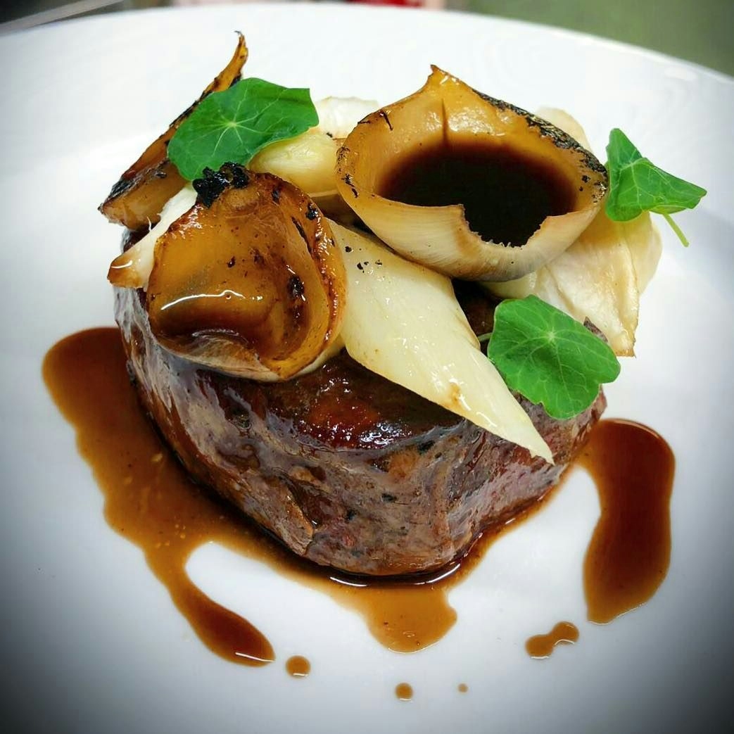 Dry aged Hereford fillet of beef served with white asparagus, celeriac and nasturtium leaves