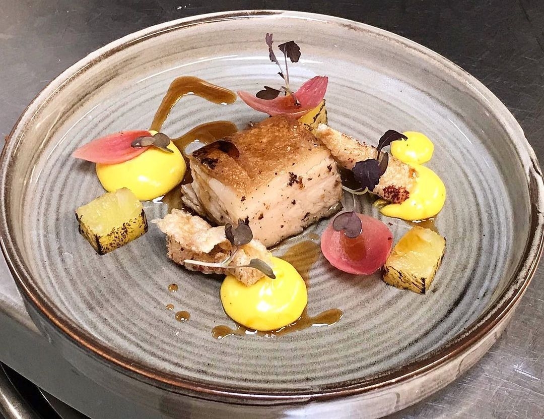 Buckmoorend farm belly of pork with confit pineapple, pickled onions, pork crackling and a mead jus